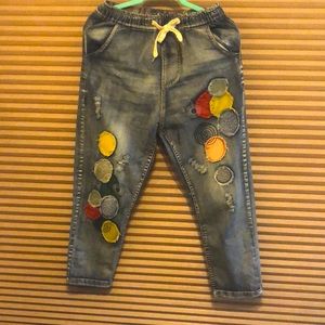 Denim jeans. Distressed pockets at the back.